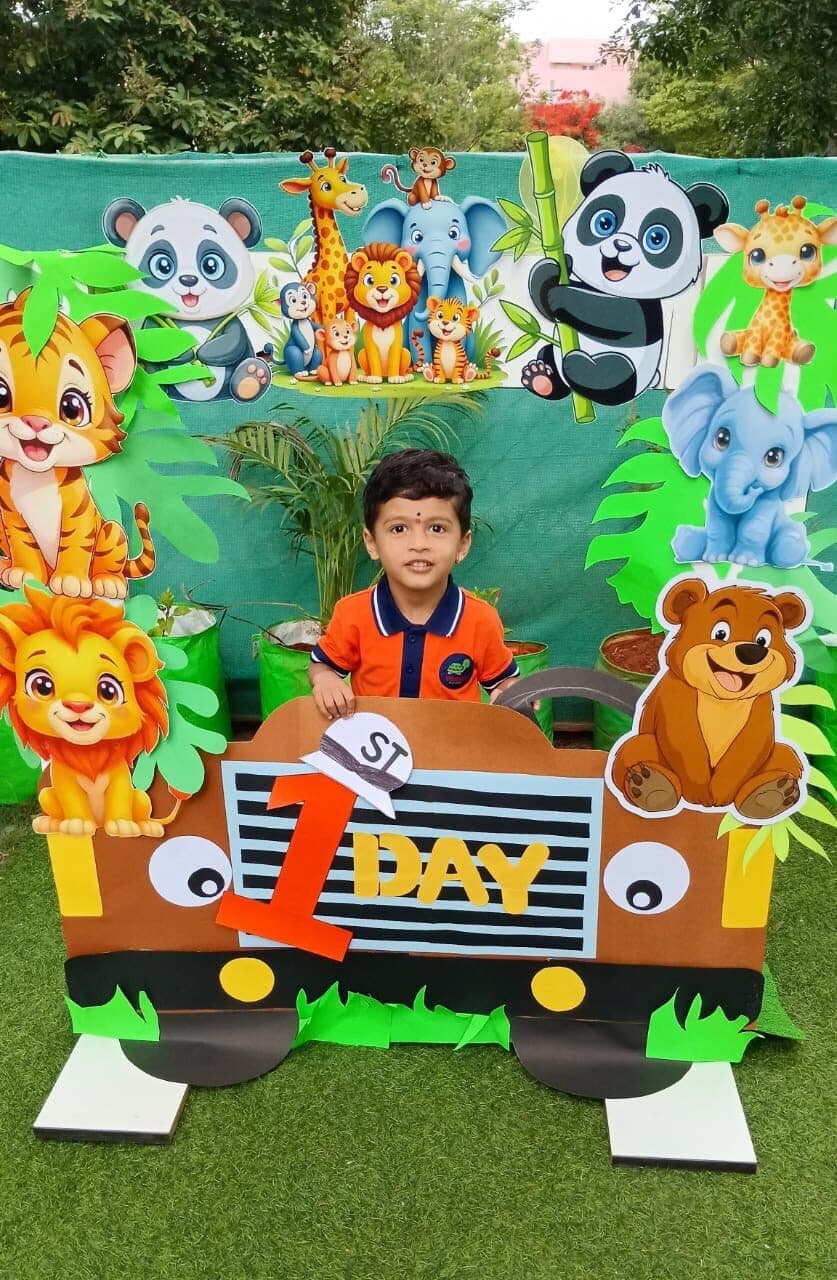 A happy little boy on his first day at Turtles Play Home, in a jungle-themed photo frame